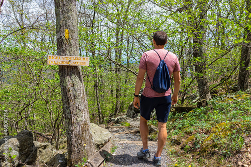 Φωτογραφία One young man with drawstring bag backpack walking on Wintergreen ski resort vil