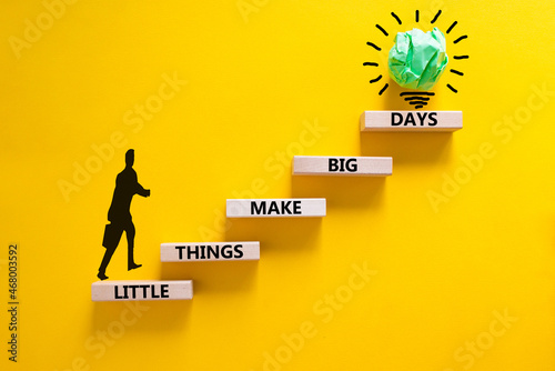 Little things make big days symbol. Wooden blocks with words Little things make big days. Beautiful yellow background, copy space. Businessman icon, light bulb. Business, motivational concept.