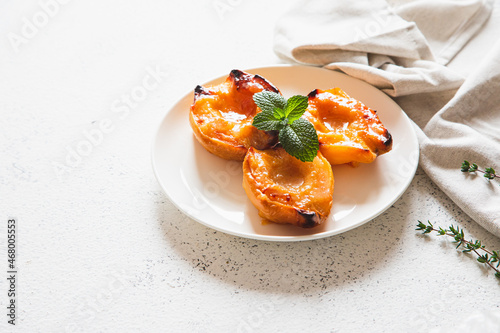 Apple quince baked with honey on a white plate with ice cream. Healthy vegetarian dessert.