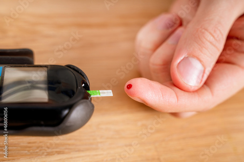Measuring blood glucose levels from a finger. Sugar control  the concept of diabetes