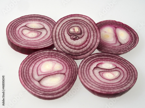 red onion slices isolated over white background. Top view. Flat lay. Red onion slice in air, without shadow.