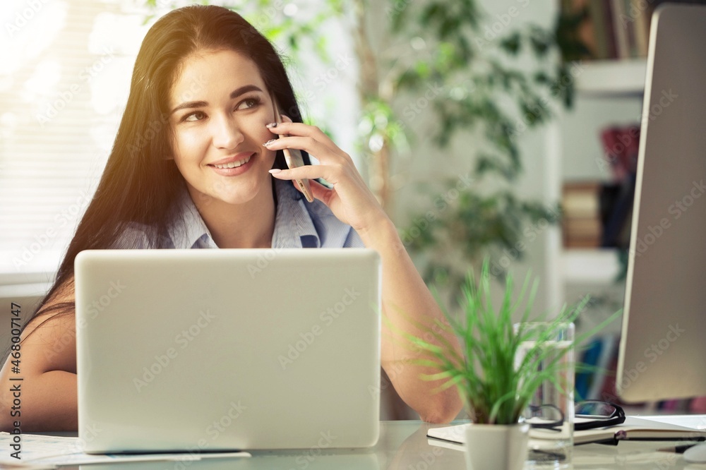 Happy business woman at workplace, making phone call on speaker Happy business woman at workplace, making phone call on speaker