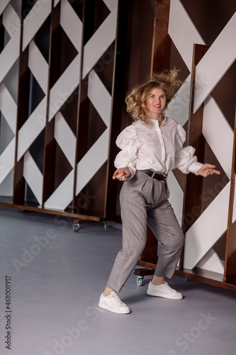 Young blonde woman posing in studio