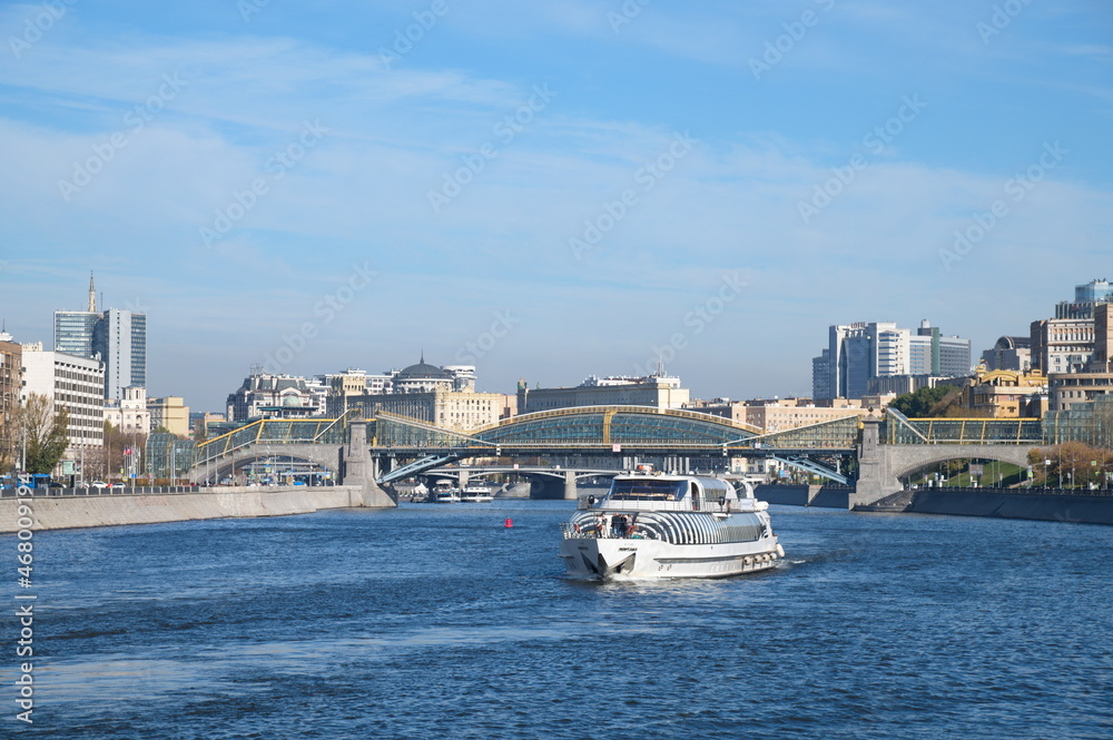 Moscow, Russia - October 9, 2021: Bogdan Khmelnitsky Bridge across the Moskva-River and a pleasure motor ship
