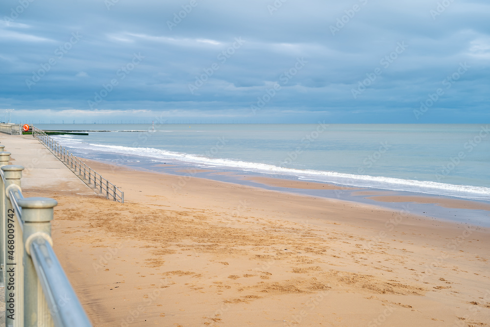 Gentle white surf on Ramsgate main sands. There is nobody on the beach on an autumn day.