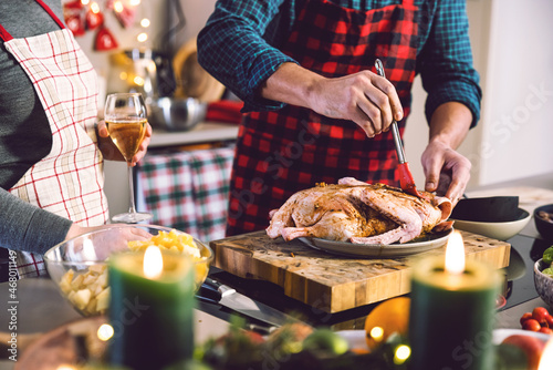  father and daughter celebrating Christmas in the kitchen cooking christmas duck or Goose