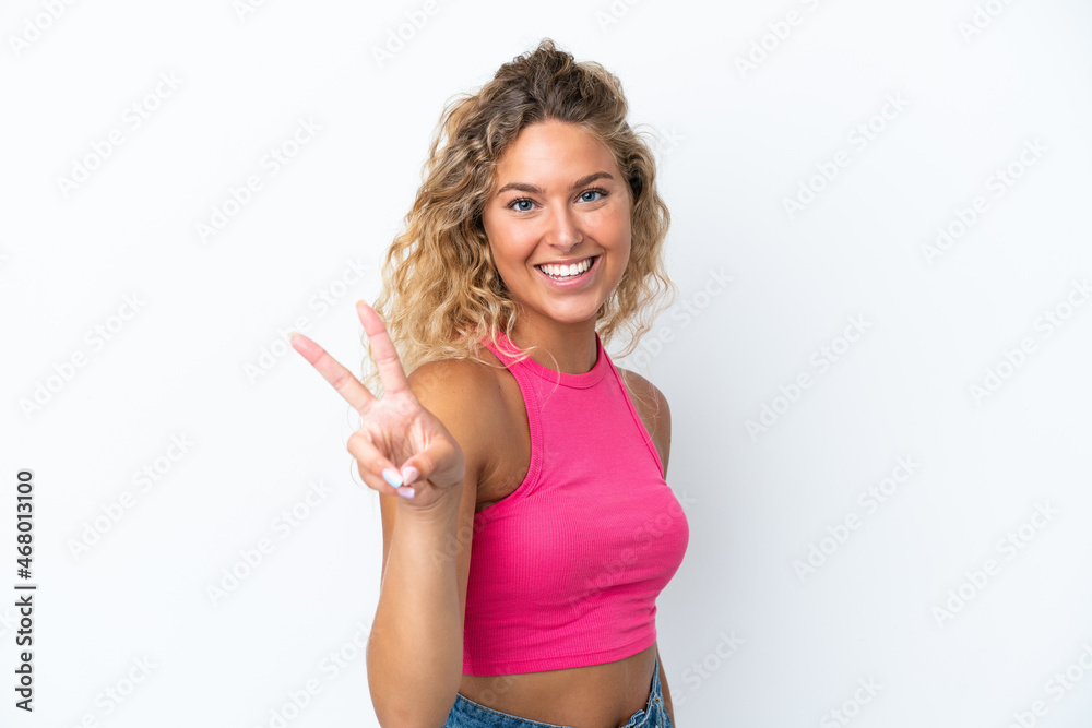 Girl with curly hair isolated on white background smiling and showing victory sign Girl with curly hair isolated on white background smiling and showing victory sign
