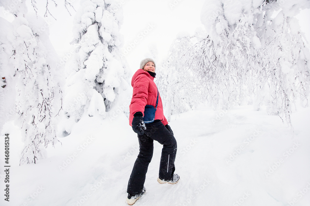 Cute girl in winter forest in Finland