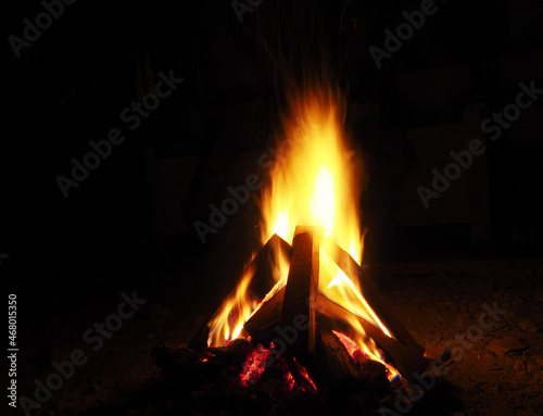 Outdoor fireplace fire, fire in the dark, burning fire in nature, glowing fire