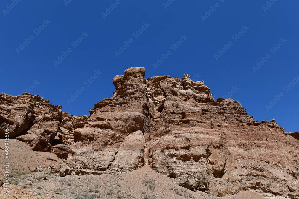 Canyon sunlit view with rocks and a pronounced texture of a yellowish stone