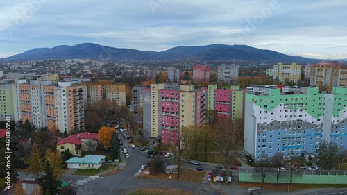Fly over blocks of flats in Bielsko Biala City. Pan right. View of mountains in background.
