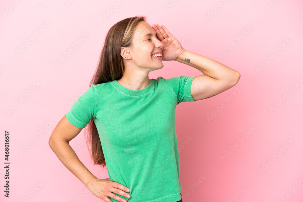 Young English woman isolated on pink background smiling a lot