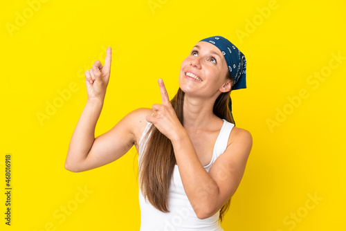 Young English woman isolated on yellow background pointing with the index finger a great idea