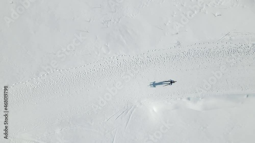 Aerial Top view of a participant in a biathlon race. Athlete overcomes the distance on skis. photo