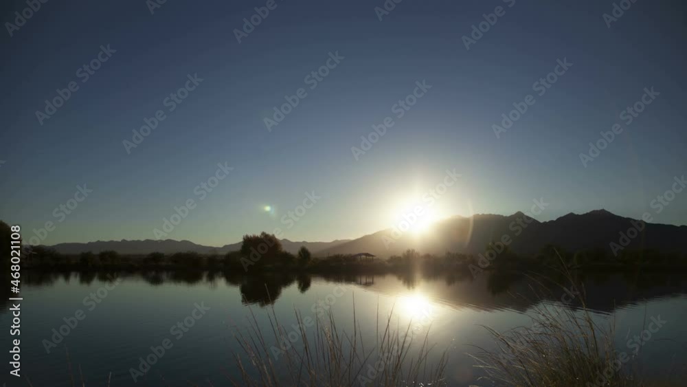 Time lapse of the sunrise over a small lake Time lapse of the sunrise over a small lake