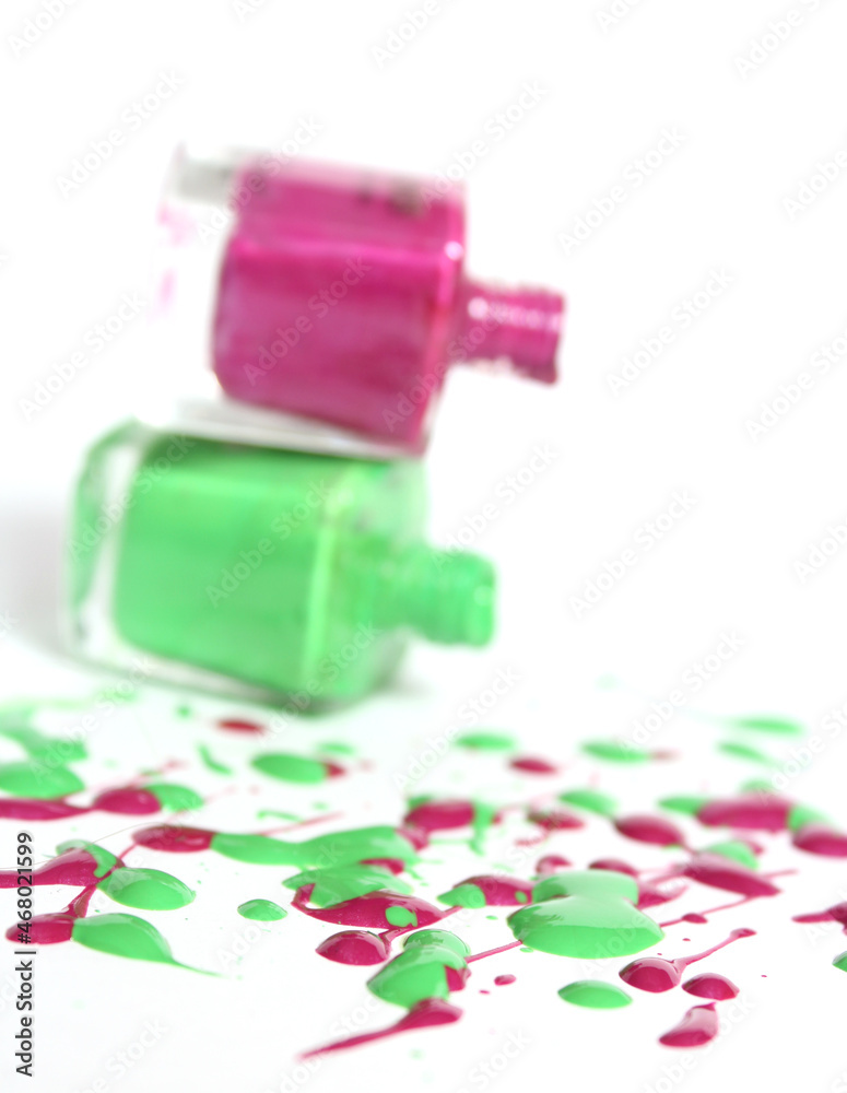 Pink and Green Spilled Nail Polish on White Background Pink and Green Spilled Nail Polish on White Background