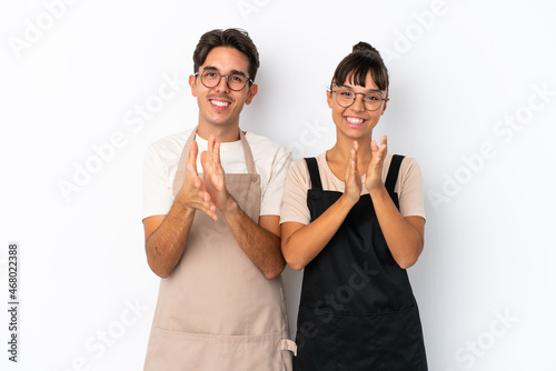 Restaurant mixed race waiters isolated on white background applauding after presentation in a conference
