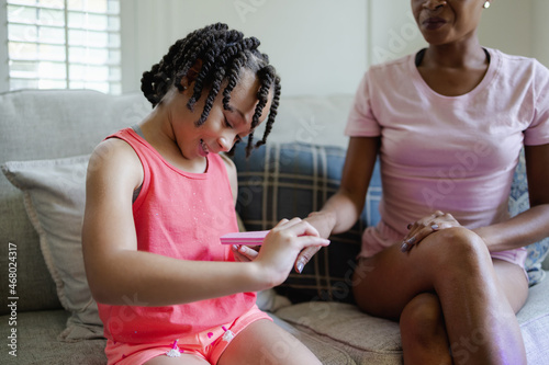 Daughter doing manicure for mother