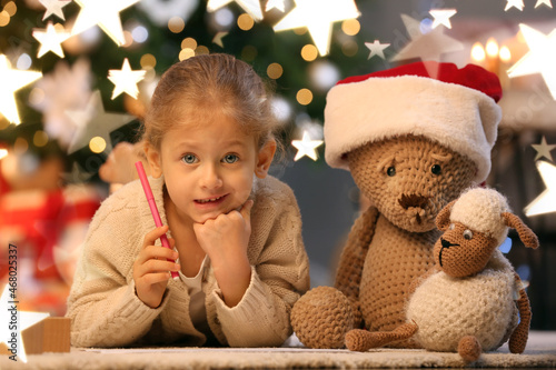 Cute little girl writing le...