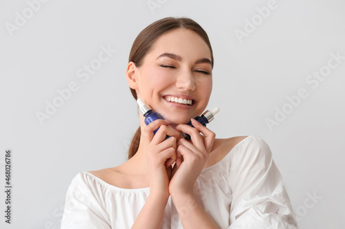 Happy woman holding bottles...