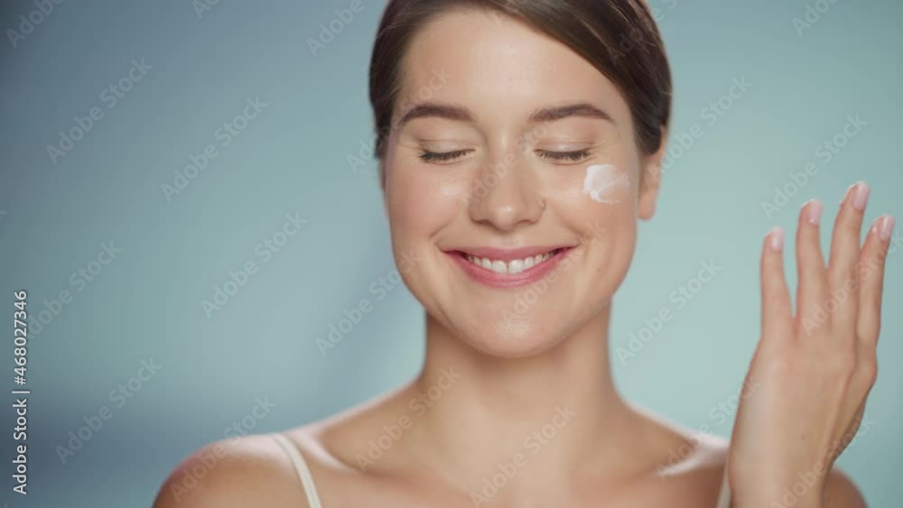 Female Beauty Portrait. Happy Caucasian Woman with Brown Hair Touching Natural, Healthy Skin, Using Sunscreen, Applying Nourishing Face Cream. Cosmetics and Skincare Concept on Isolated Background. Female Beauty Portrait. Happy Caucasian Woman with Brown Hair Touching Natural, Healthy Skin, Using Sunscreen, Applying Nourishing Face Cream. Cosmetics and Skincare Concept on Isolated Background.