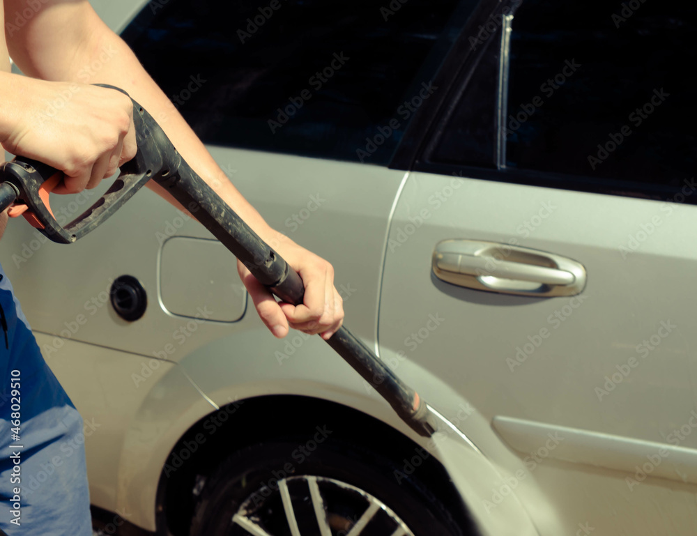 washing silver car with pressurized water washing silver car with pressurized water