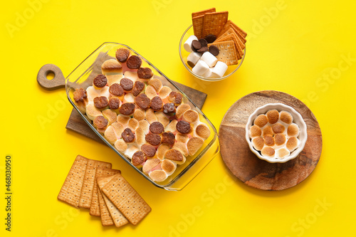 Composition with tasty S'mores dip on yellow background photo