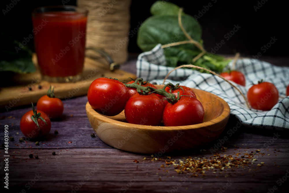 cherry tomatoes and tomato juice on a black background. Tomato cocktail with tomatoes cherry tomatoes and tomato juice on a black background. Tomato cocktail with tomatoes