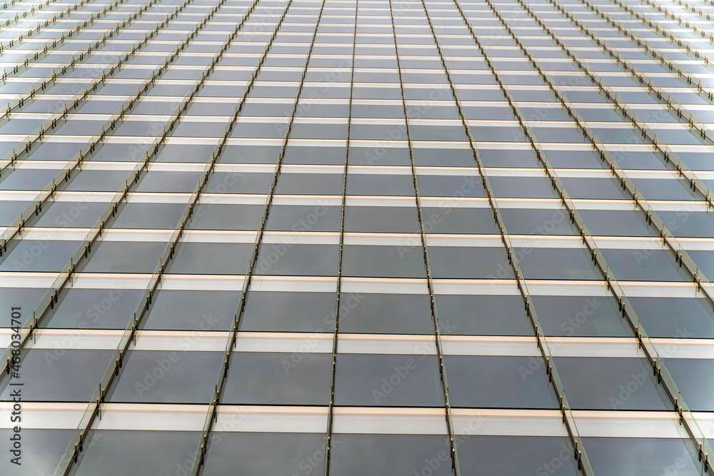 Tinted glass curtain wall of a building with vertical glass beams at Salt Lake City, Utah Tinted glass curtain wall of a building with vertical glass beams at Salt Lake City, Utah