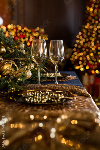 Empty glasses close up. Beautiful table setting with Christmas decorations in living room