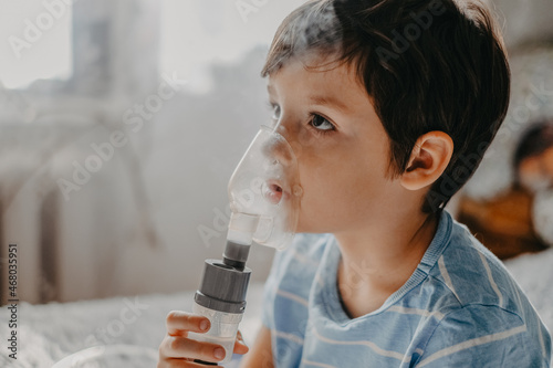 sick child breathes in a nebulizer