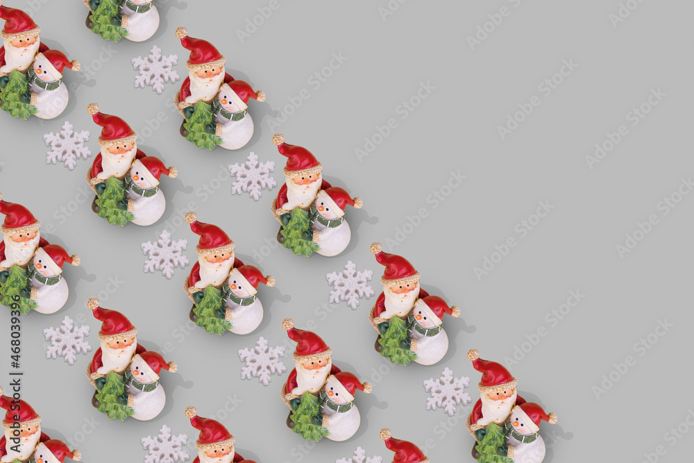 Creative Christmas pattern with Snowman and Santa Claus  in an embrace on a gray background.