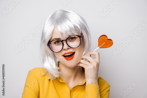 attractive woman with glasses white wig lollipop fashion glamor © VICHIZH