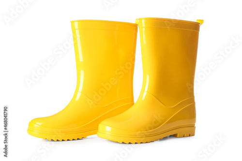 Pair of yellow rubber boots on white background