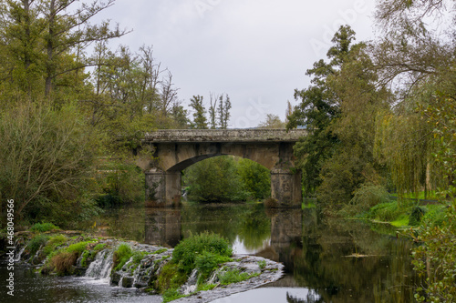 Roman bridge over river, Vilanova bridge, over the Arnoia river in Allariz, Ourense, Galicia, Spain photo