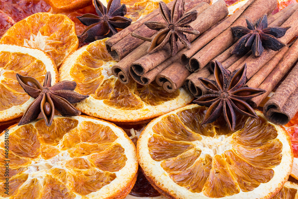 Dried citrus orange slices, Cinnamon sticks and Anise stars, background. Aromatic spices for Drink, cooking or baking. Macro High resolution photo. Professional food photography. Full depth of field. Dried citrus orange slices, Cinnamon sticks and Anise stars, background. Aromatic spices for Drink, cooking or baking. Macro High resolution photo. Professional food photography. Full depth of field.