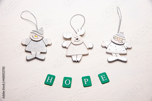 Flat lay of Christmas ornaments on a table with words of hope