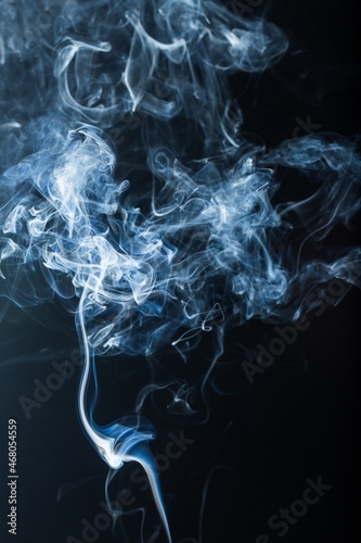 The abstract pattern made from smoke rising from an incense stick.