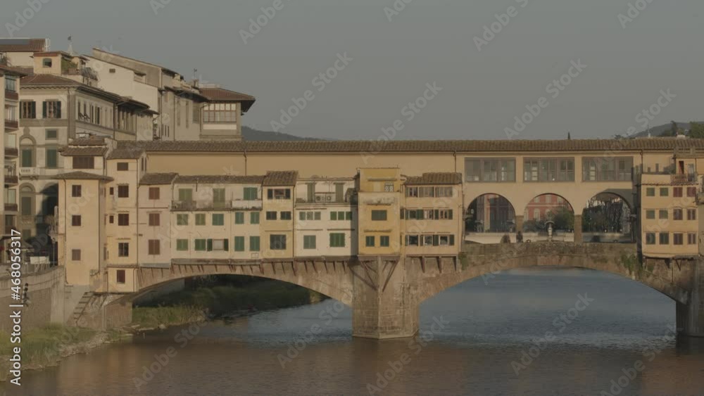 Pan of Ponte Vecchio in Florence with only a person walking over during lockdown in Italy Pan of Ponte Vecchio in Florence with only a person walking over during lockdown in Italy