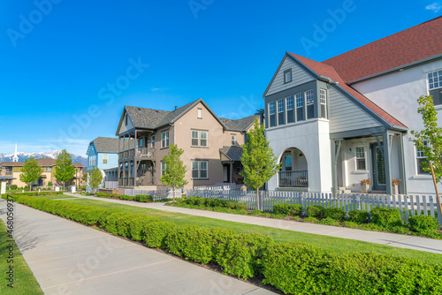 Large traditional houses exterior with white picket fence at Daybreak, Utah