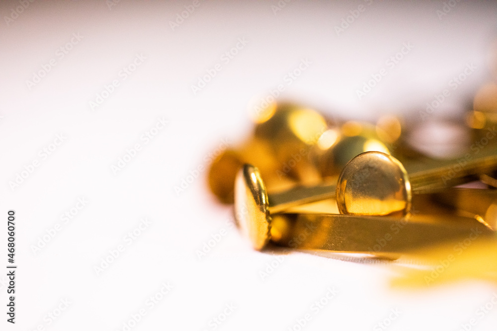 Golden metal fasteners for books and screenplays with white background. Golden metal fasteners for books and screenplays with white background.