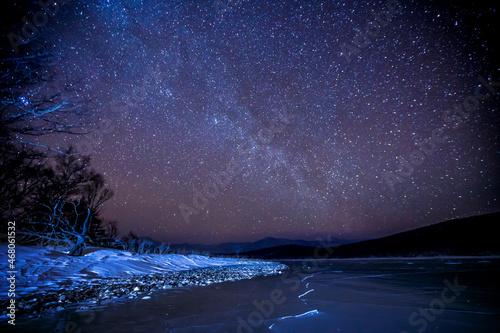 Starry sky over a frozen winter lake. Milky Way. Sikhote-Alin Biosphere Reserve in the Primorsky Territory. photo