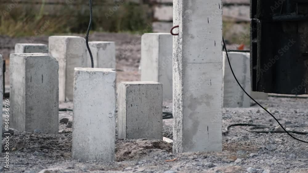 A piledriving hydraulic installation hammers piles into the ground at