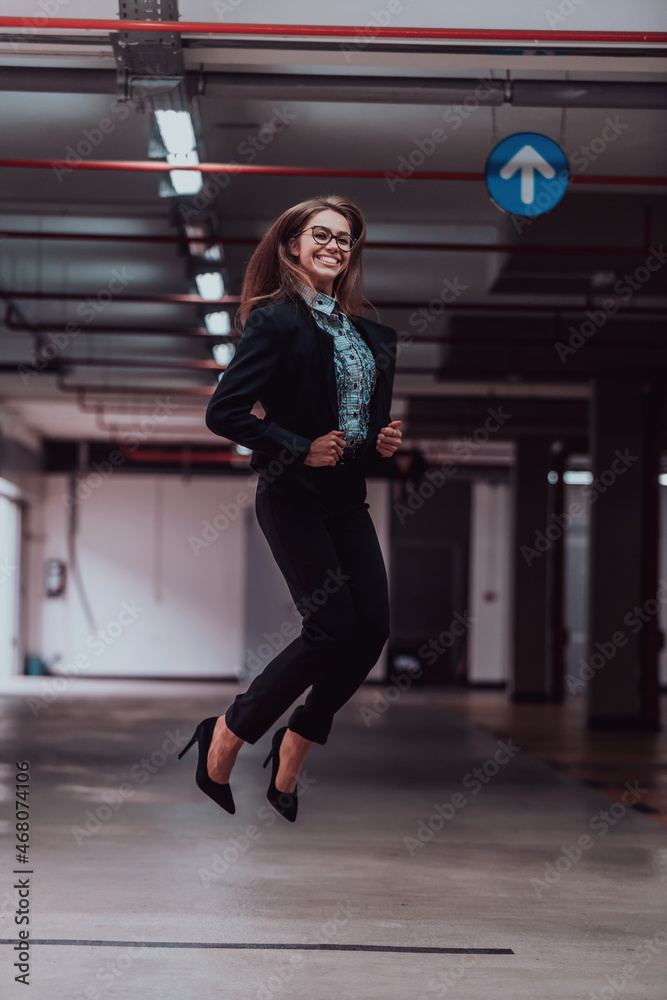 A successful business woman celebrates her job by jumping into the air. Selective focus