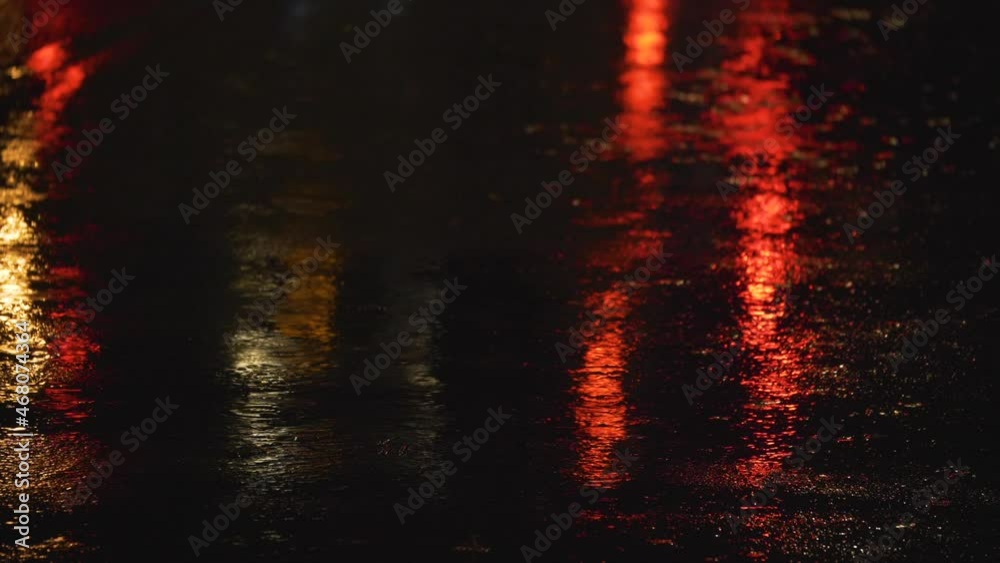 Rain. Puddles On The Asphalt. This is an amazing stock video that shows footage of rain in a night city. The lights of the night city are reflected in puddles on the asphalt. 