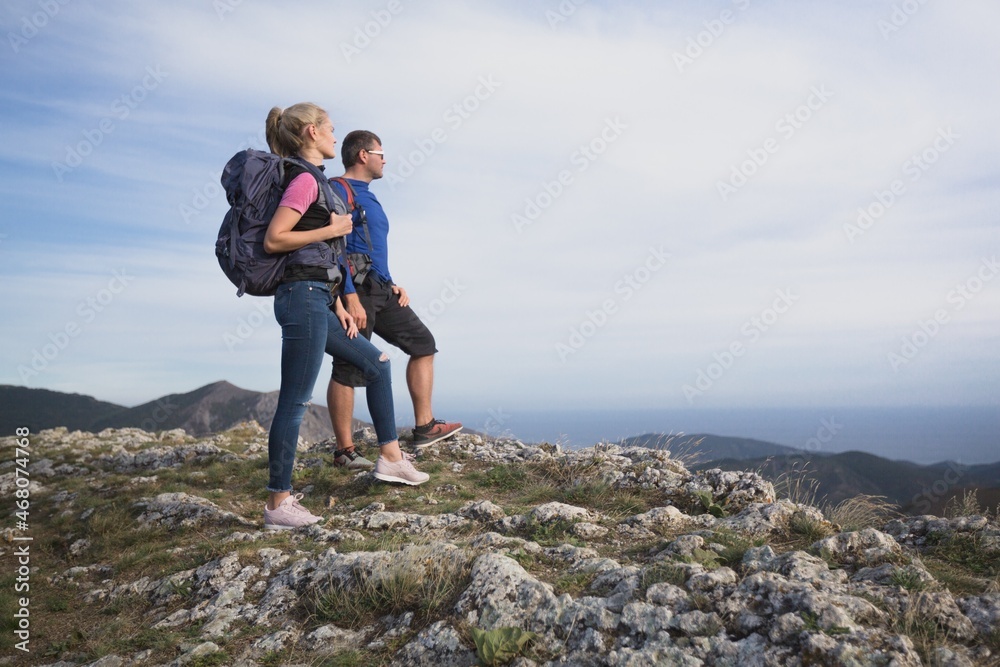 Senior tourist couple travellers hiking in nature background