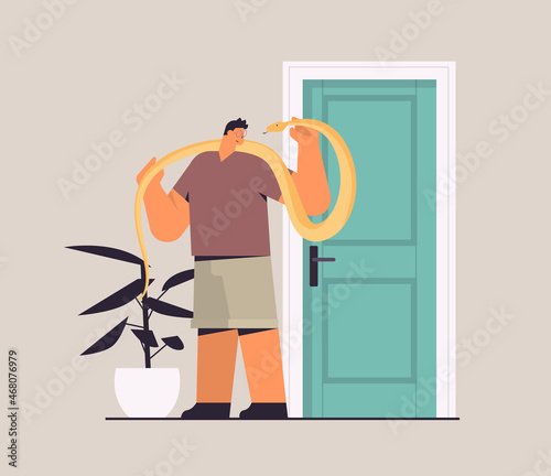 man holding yellow python snake guy having dangerous reptile pet horizontal full length