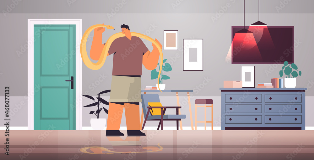 man holding yellow python snake guy having dangerous reptile pet living room interior horizontal man holding yellow python snake guy having dangerous reptile pet living room interior horizontal