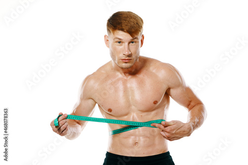 athletic man with measuring tape muscle workout