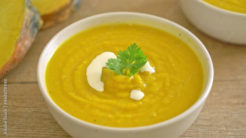 pumpkin soup in white bowl - Vegetarian and vegan food style pumpkin soup in white bowl - Vegetarian and vegan food style